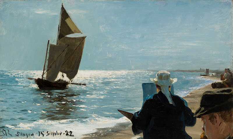 Kvinna målar på en strand.